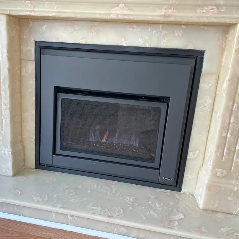 Regency gas insert fitted into an onyx marble mantel